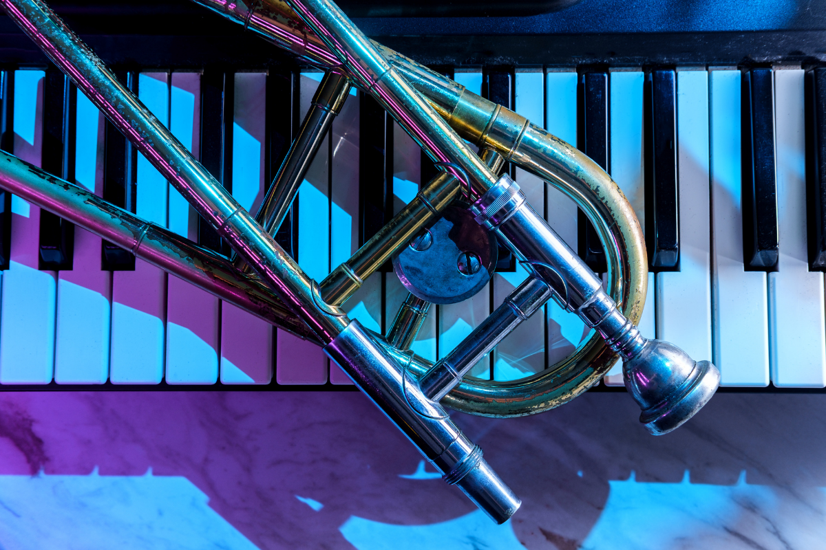 a trombone laying on a keyboard